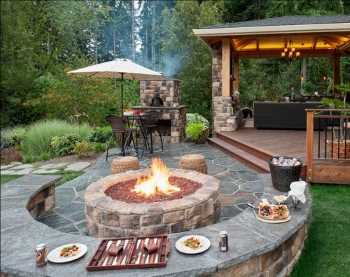 Backyard fire pit, stone seat wall, Frisco TX backyard, natural stone outdoor living area.