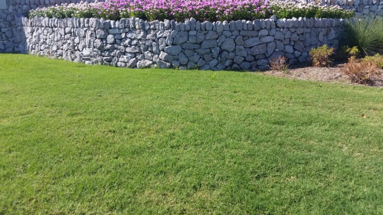 Dry stacked stone wall garden bed borders