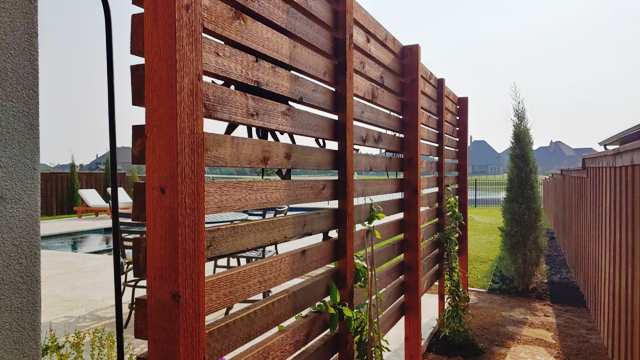 Wooden privacy screens installed for backyard retreat