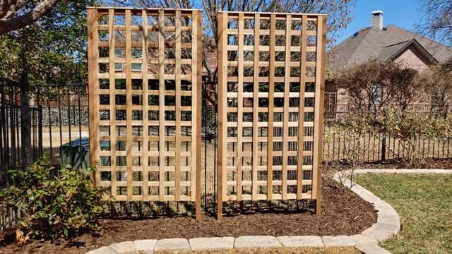 Wooden trellis panels used to block view of backyard
