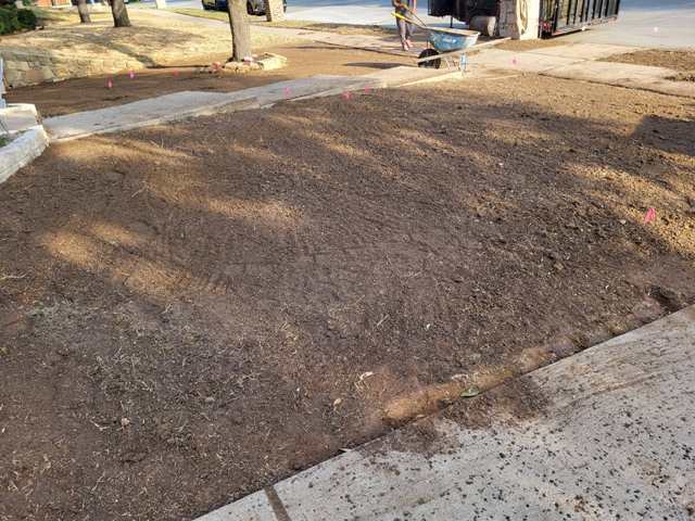 Landscapers Grading Lawn as a Yard Drainage Solution